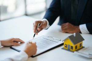 two people signing mortgage agreement