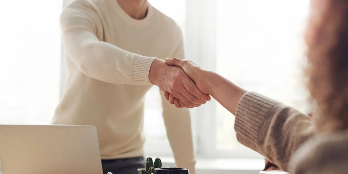Man shaking woman's hand after securing a mortgage